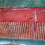 blue red striped art deteriorating on wall